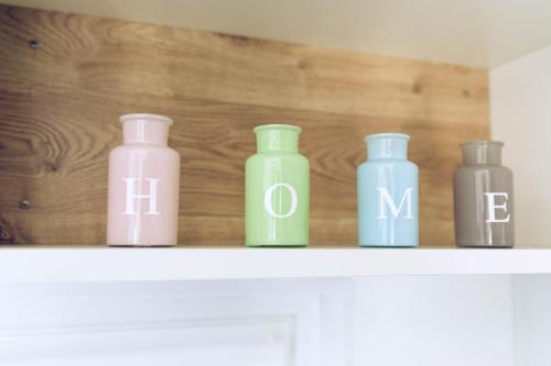 four different colored bottles sitting on a shelf at Regenbogen Göhren in Göhren