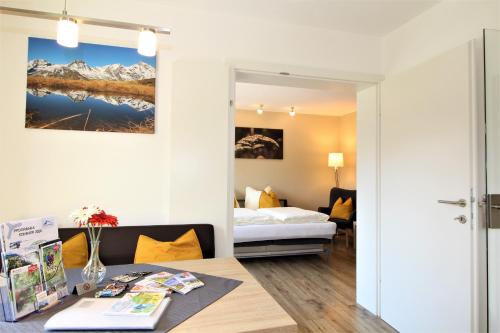 a hotel room with a bed and a desk at Appartements Cilli in Neukirchen am Großvenediger