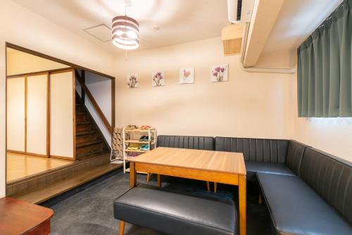 a dining room with a table and benches at JPRESERVE Toji in Kyoto