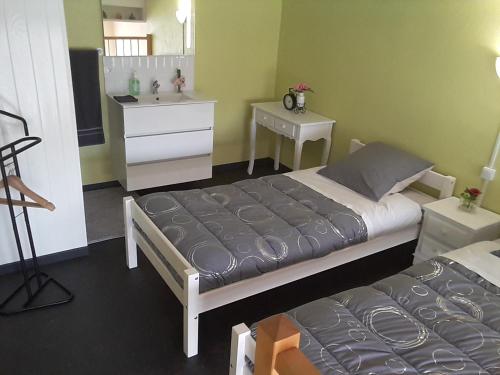 a bedroom with a bed and a dresser and a mirror at Le Relais des Ducs in Duras