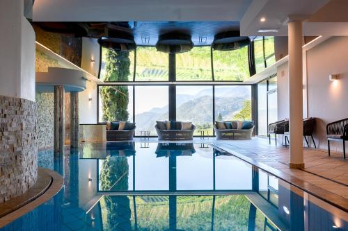 a house with a pool with a view at Das Grafenstein Familienresidence in Cermes