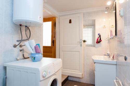 a bathroom with a washing machine and a sink at Do you want to fully enjoy Old Town in Dubrovnik