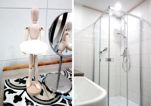 a bathroom with a shower and a sink and a mirror at Malvasia Apart in Stumm
