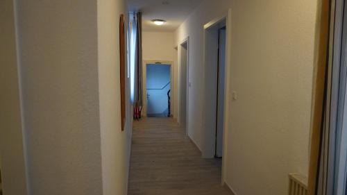 a hallway with a long corridor with two different rooms at Gasthaus Schöne Aussicht in Usingen