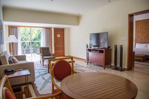 a living room with a room with a bed and a television at Mandarin Oriental, Sanya in Sanya