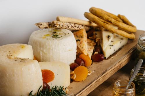 a plate of cheese and other foods on a table at Cyano Hotel in Plakias