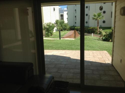 an open door to a patio with a view of a yard at Villas at Bahia Mar in South Padre Island