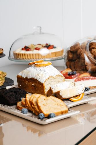 a table with various types of bread and pastries at Cyano Hotel in Plakias