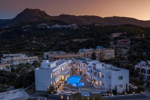 an aerial view of a house with a mountain in the background at Cyano Hotel in Plakias