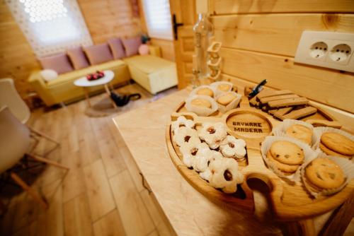 a table filled with different types of bread and cookies at Brvnare MADERA Banja Ždrelo in Ždrelo