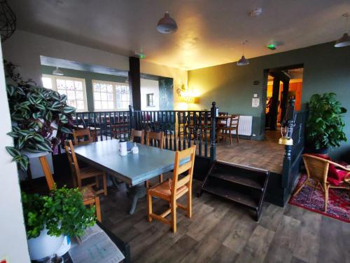 a dining room with a table and chairs at Comrie Croft in Crieff