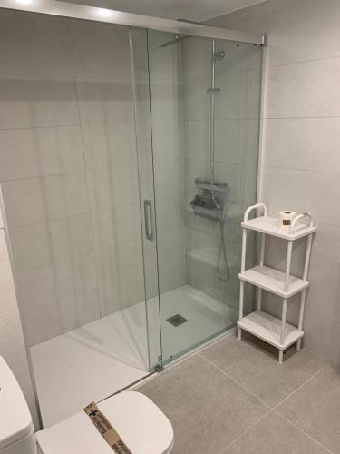 a shower with a glass door in a bathroom at Apartamento Plaza Pradollano 1 in Sierra Nevada