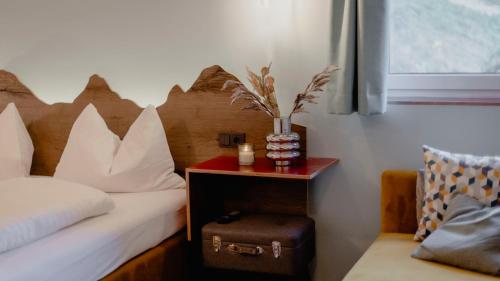 a bedroom with a bed and a table with a night stand at Bett & Berg Bad Ischl, Self Check-In in Bad Ischl