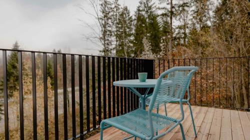 a blue table and a chair on a balcony at Bett & Berg Bad Ischl, Self Check-In in Bad Ischl