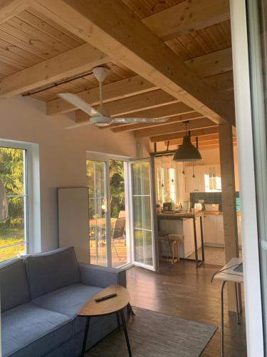 a living room with a couch and a table at Między Brzozami in Pieczarki