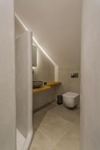 a bathroom with a toilet and a sink at Barbarigos luxury spa apartments in Naousa