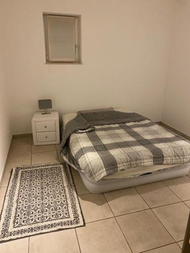 a bedroom with a bed and a nightstand and a bed sidx sidx sidx sidx at 10mins from Brussels Airport 2 rooms living room and Patio in Zaventem