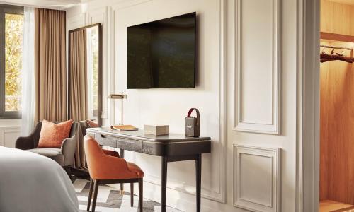 a hotel room with a desk and a bed at Rosewood Villa Magna in Madrid