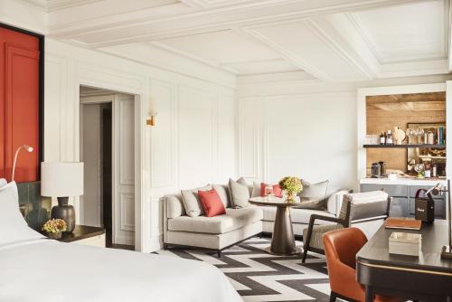 a bedroom with a bed and a living room at Rosewood Villa Magna in Madrid