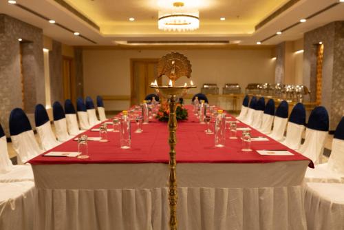 a long table with a red and white table cloth at Hotel Deep Clarks Inn Lucknow in Lucknow