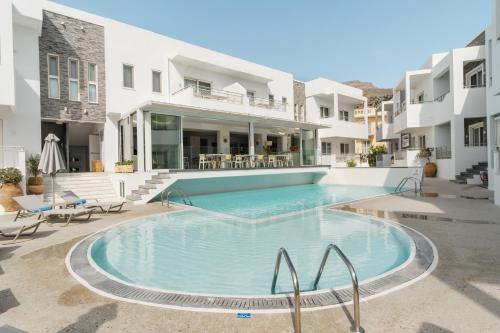 a large swimming pool in the middle of a building at Cyano Hotel in Plakias