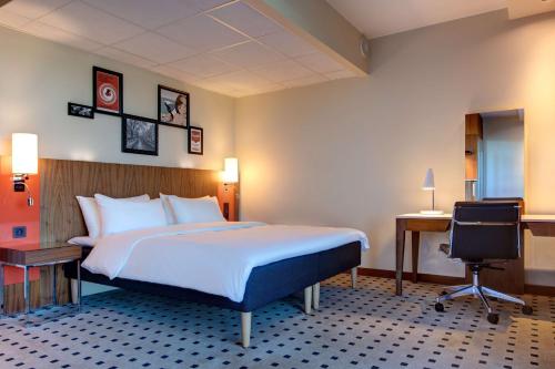a hotel room with a bed and a desk at Radisson Blu Hotel Oslo Alna in Oslo