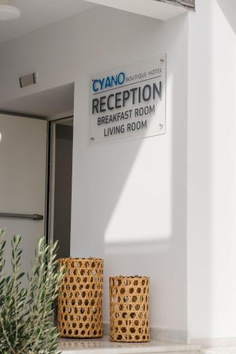 a sign on the side of a building that reads regeneration breakfast room living room at Cyano Hotel in Plakias