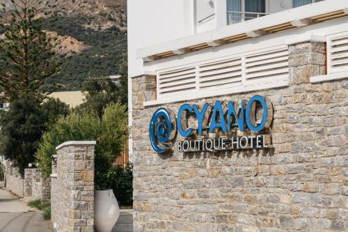 a sign on the side of a building at Cyano Hotel in Plakias