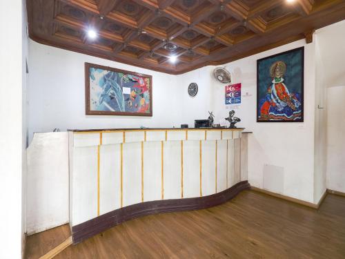 a room with white walls and a wooden floor at The Byke Puja Samudra in Kovalam