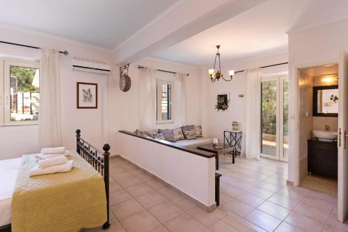 a bedroom with a bed and a bathroom at The Artemis Home, pure rustic romance, By ThinkVilla in Astérion