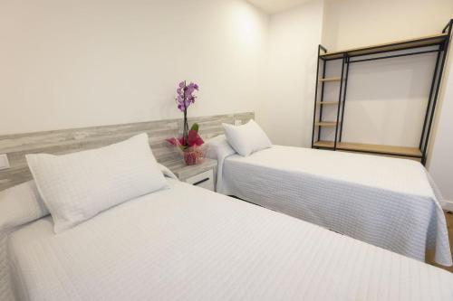 A bed or beds in a room at Apartamentos Centro Llanes