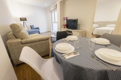 a living room with a table and a couch at Apartamentos Centro Llanes in Llanes