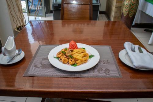 a plate of food on a table with a plate of pasta at Hotel Rio in Nairobi