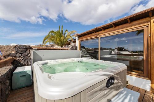 a jacuzzi tub on the deck of a house at Villasal in Playa Blanca