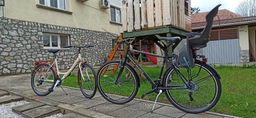 two bikes are parked outside of a house at La Siesta Bogács Apartman in Bogács