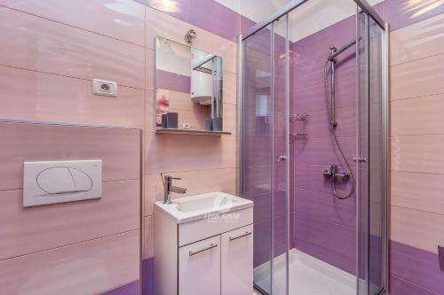 a bathroom with a shower and a sink at Villa Brcina in Pula
