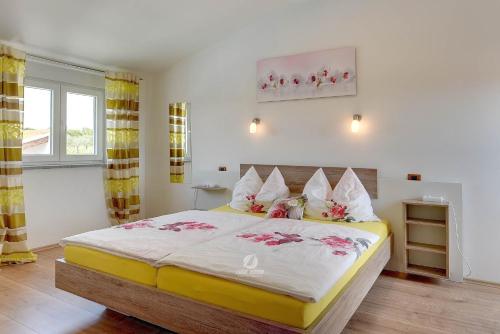 a bedroom with a large bed with flowers on it at Ferienhaus Brcina in Pula