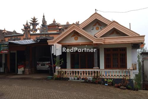 a building with a red partner sign on it at Gebby Homestay Bromo RedPartner in Pasuruan