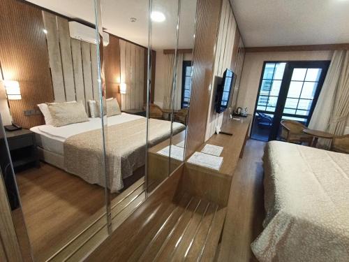 a hotel room with two beds and two lamps at bahçelievler hotels in Ankara