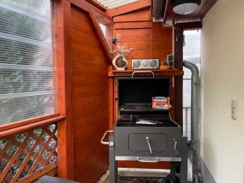 a small room with a stove and a tv in a house at Ferienhaus Zschieck in Torno