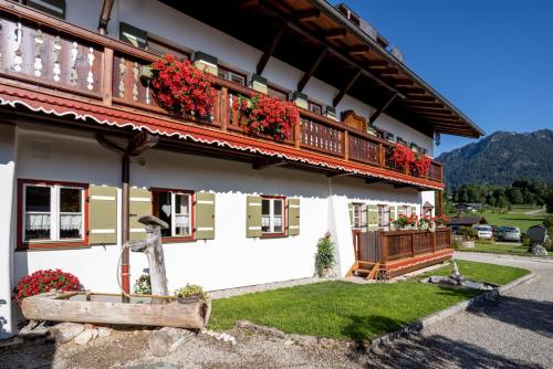 a house with flowers on the balconies of it at Gästehaus Hinterponholz in Ramsau