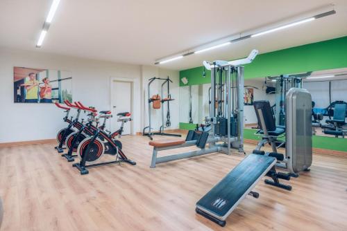a gym with several treadmills and exercise bikes at Iberostar Waves Las Dalias All Inclusive in Adeje