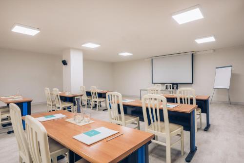 a classroom with tables and chairs and a whiteboard at Iberostar Waves Las Dalias All Inclusive in Adeje