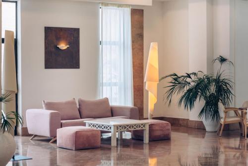 a living room with a couch and a table at Iberostar Waves Las Dalias All Inclusive in Adeje