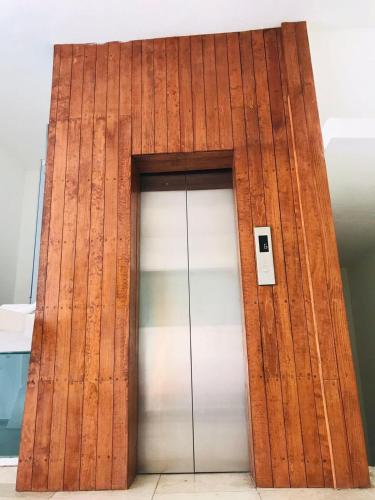 a brown and white building with two doors at VILLA COSTERA HOTEL BOUTIQUE in Acapulco