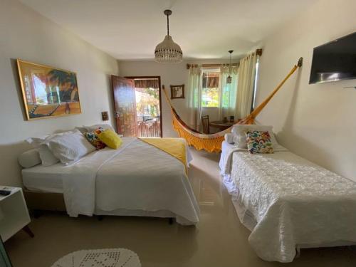 A bed or beds in a room at Pousada Potigua
