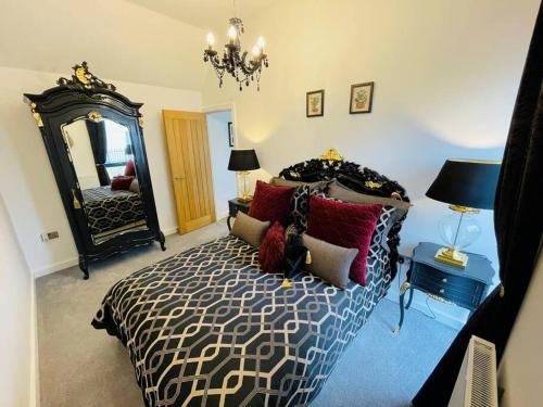 a bedroom with a bed and a large mirror at 3 The Salt Yard, Whitstable - free parking, centre of town, 2 min walk to beach in Whitstable