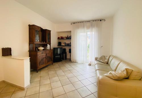 a living room with a couch and a window at Dimora Concept - Casa Leon - Bike room in Finale Ligure