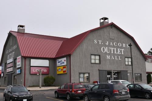 a building with cars parked in a parking lot at Hammer Haus III in Waterloo