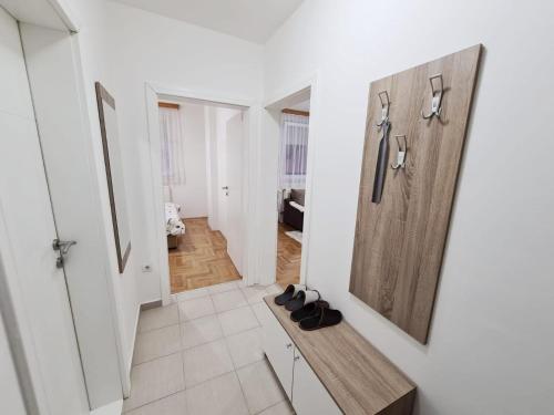 a hallway with a bench and a door at Apartman City in Bijeljina